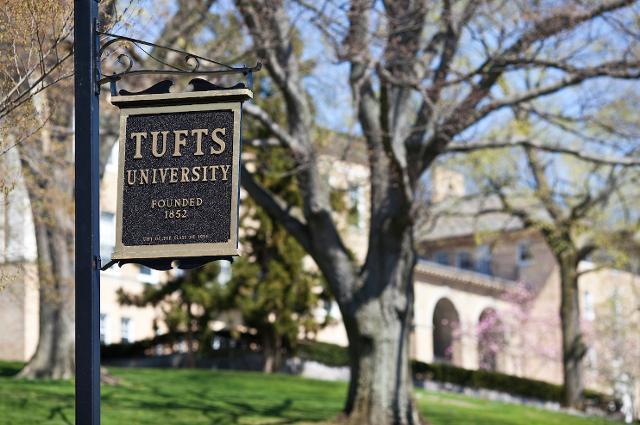 Tufts University sign in front of tree